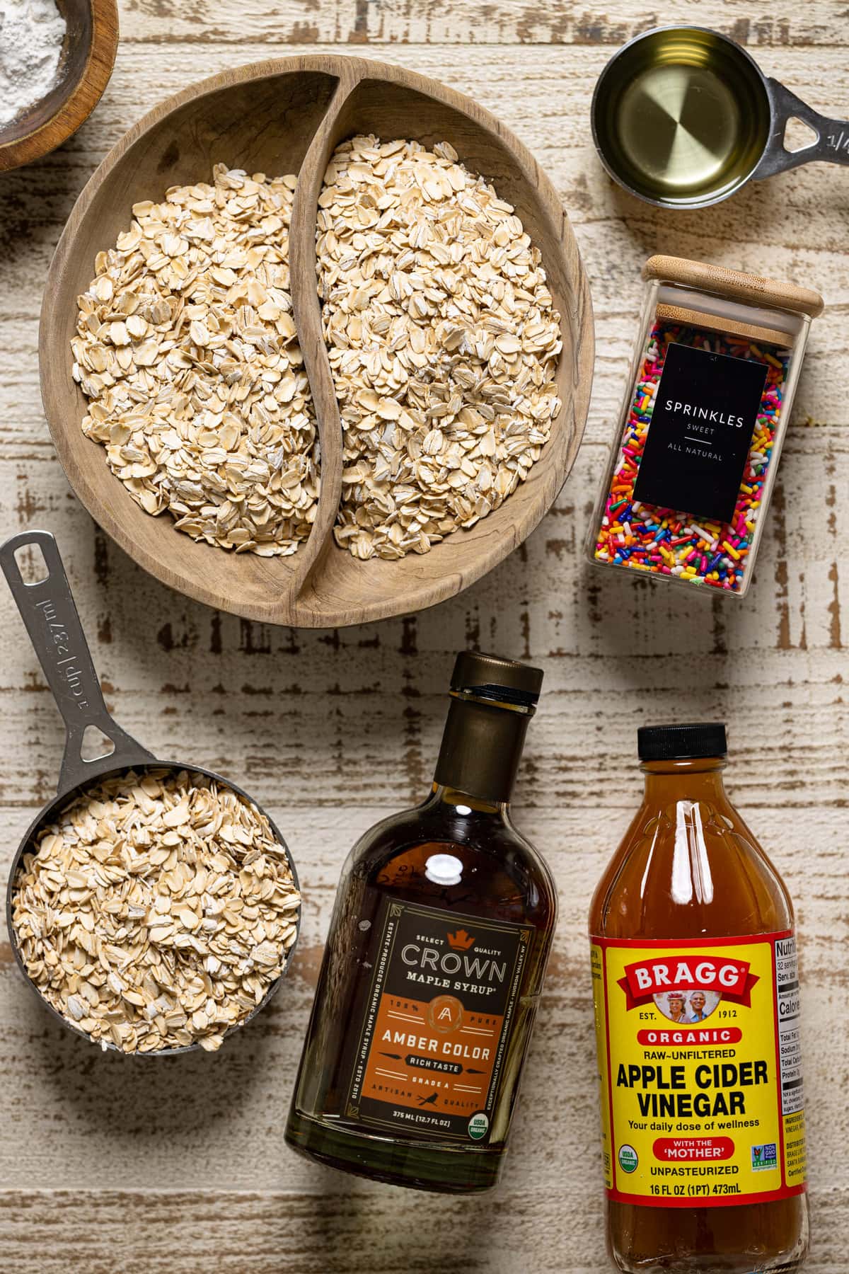 Ingredients for Funfetti Oatmeal Vegan Waffles including sprinkles, apple cider vinegar, and maple syrup