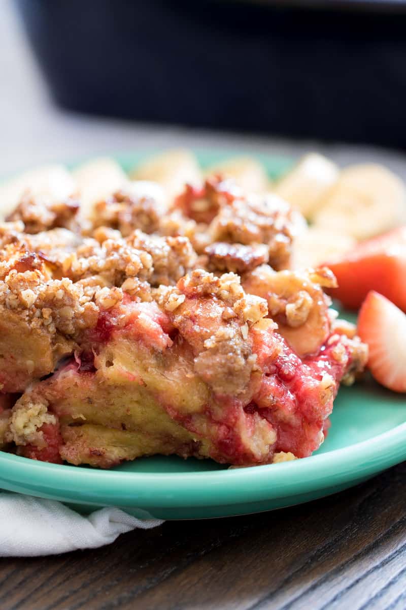 Baked Strawberry Banana French Toast Casserole on a light blue plate.