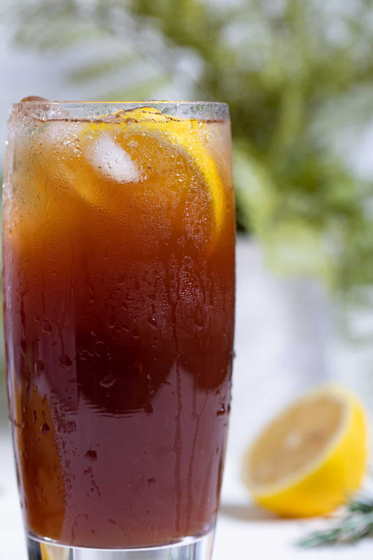 Traditional Southern Iced Sweet Tea in a glass with lemon slices.