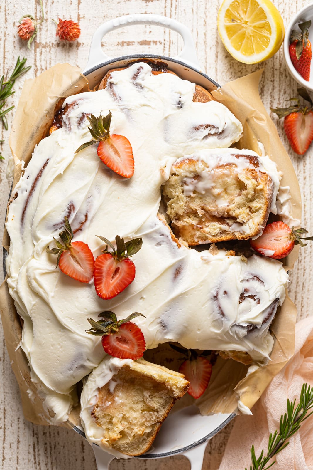Overhead shot of a Dutch Oven of Strawberry Sweet Rolls with Lemon Cream Cheese Glaze