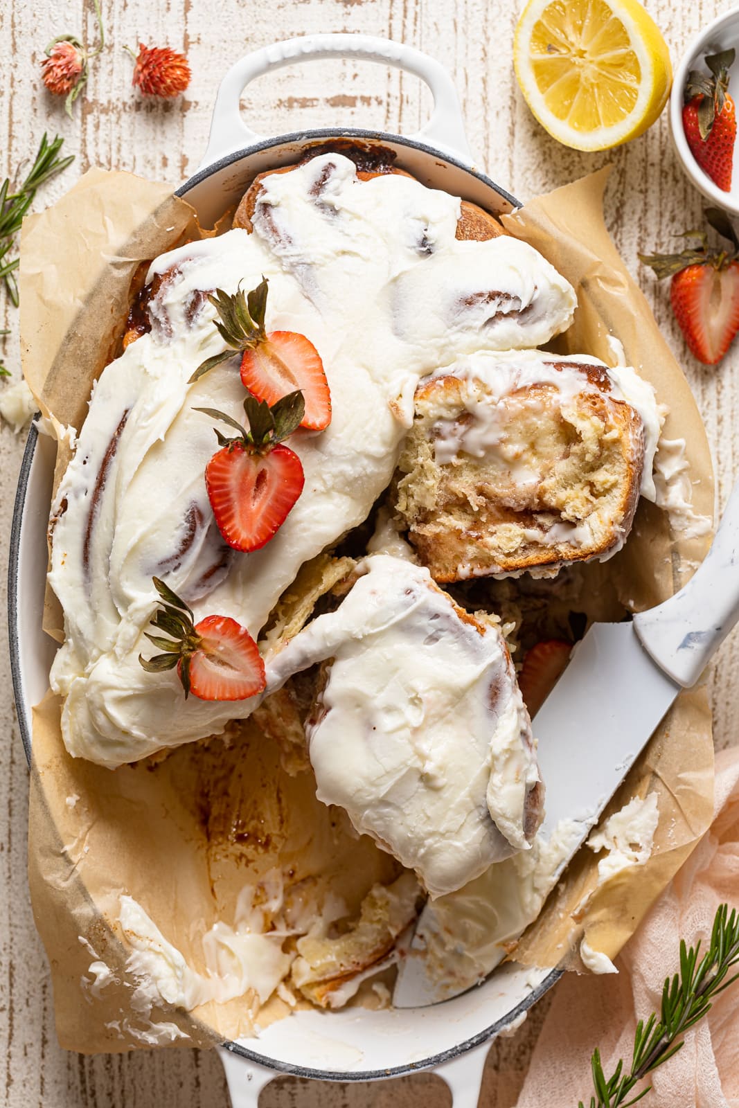 Dutch oven half-full of Strawberry Sweet Rolls with Lemon Cream Cheese Glaze