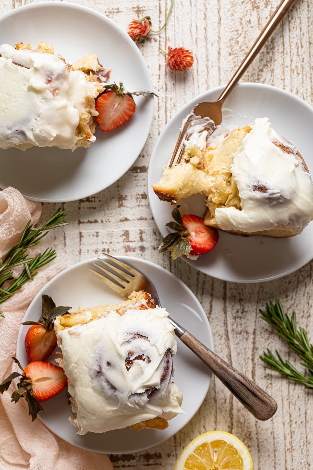 Small plates of Strawberry Sweet Rolls with Lemon Cream Cheese Glaze