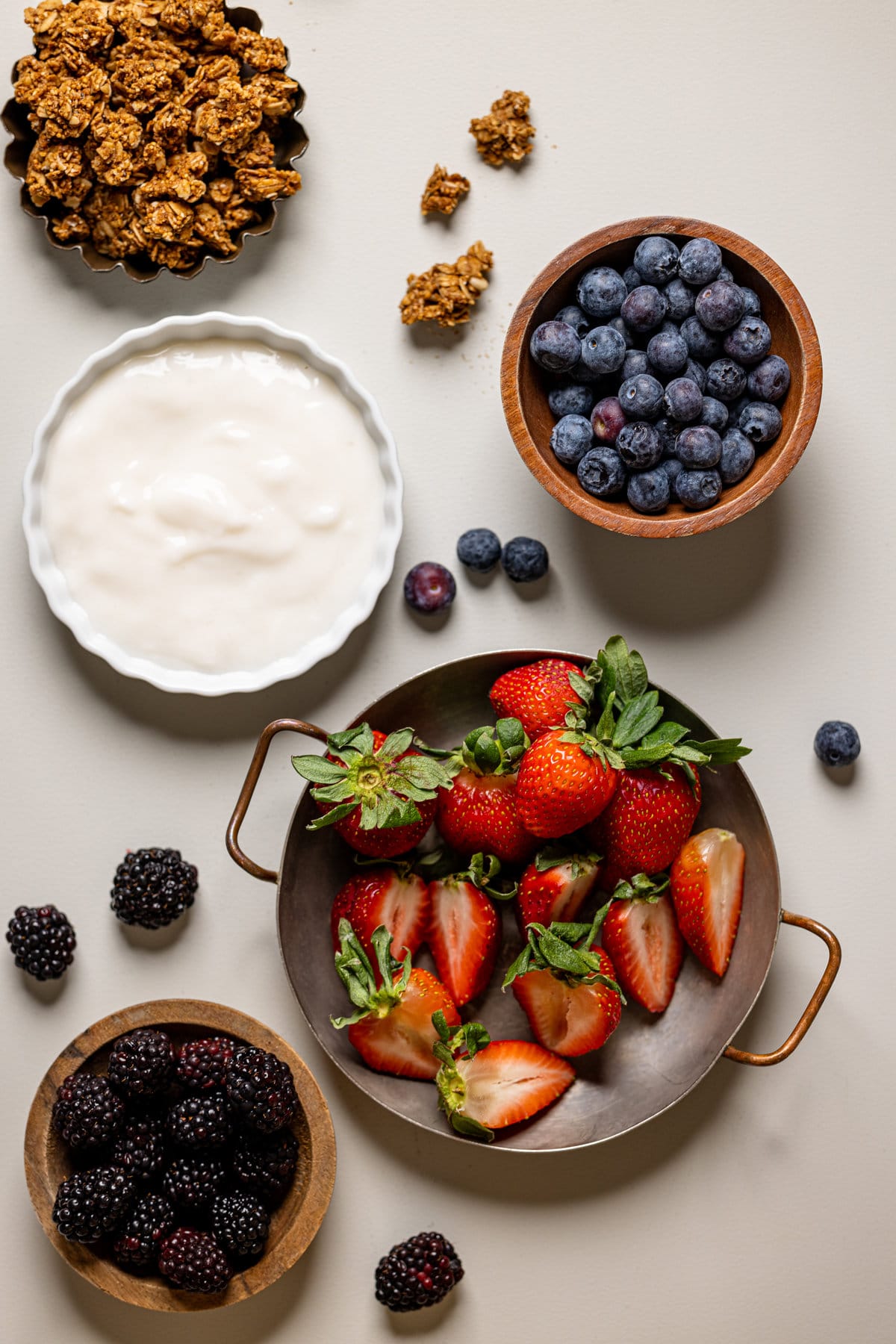 Ingredients for Sweet Potato Berry Breakfast Boats including blueberries, strawberries, and granola