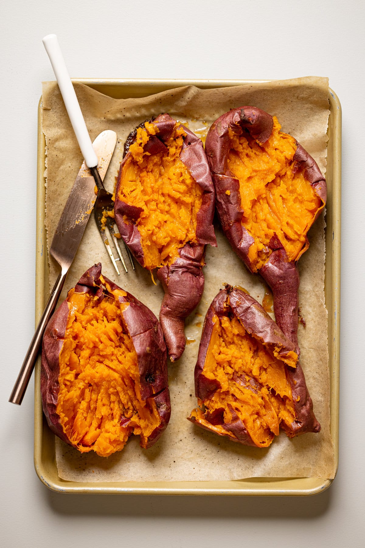 Roasted sweet potatoes cut open and mashed