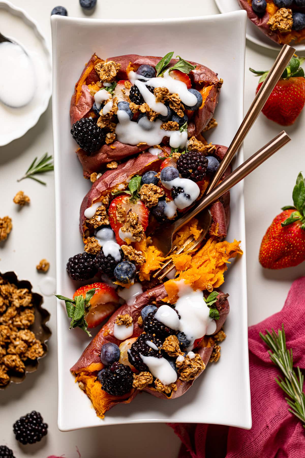 Plate with three sweet potato berry breakfast boats drizzled with yogurt