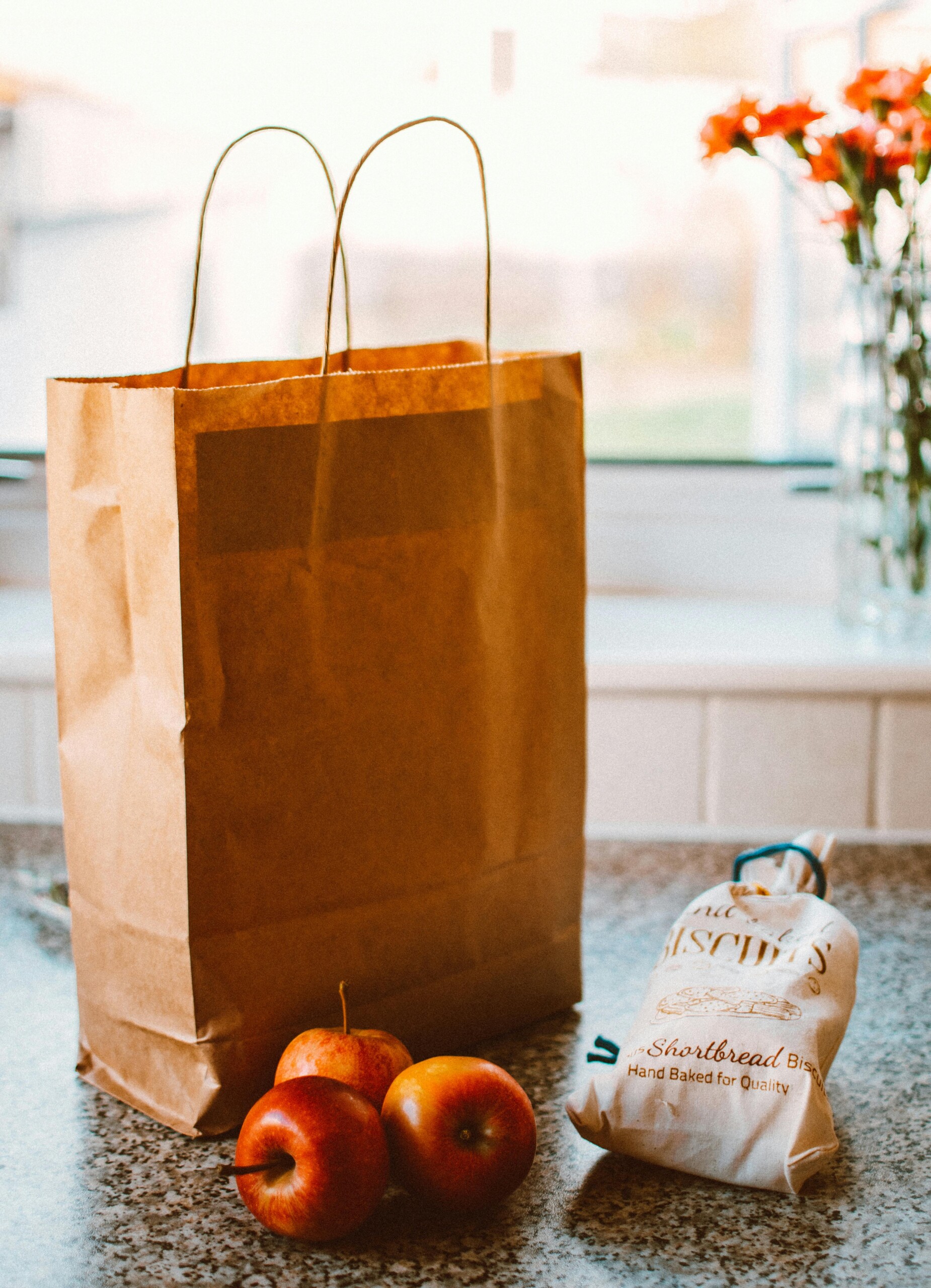 Image of a grocery bag on a kitchen counter with food.
