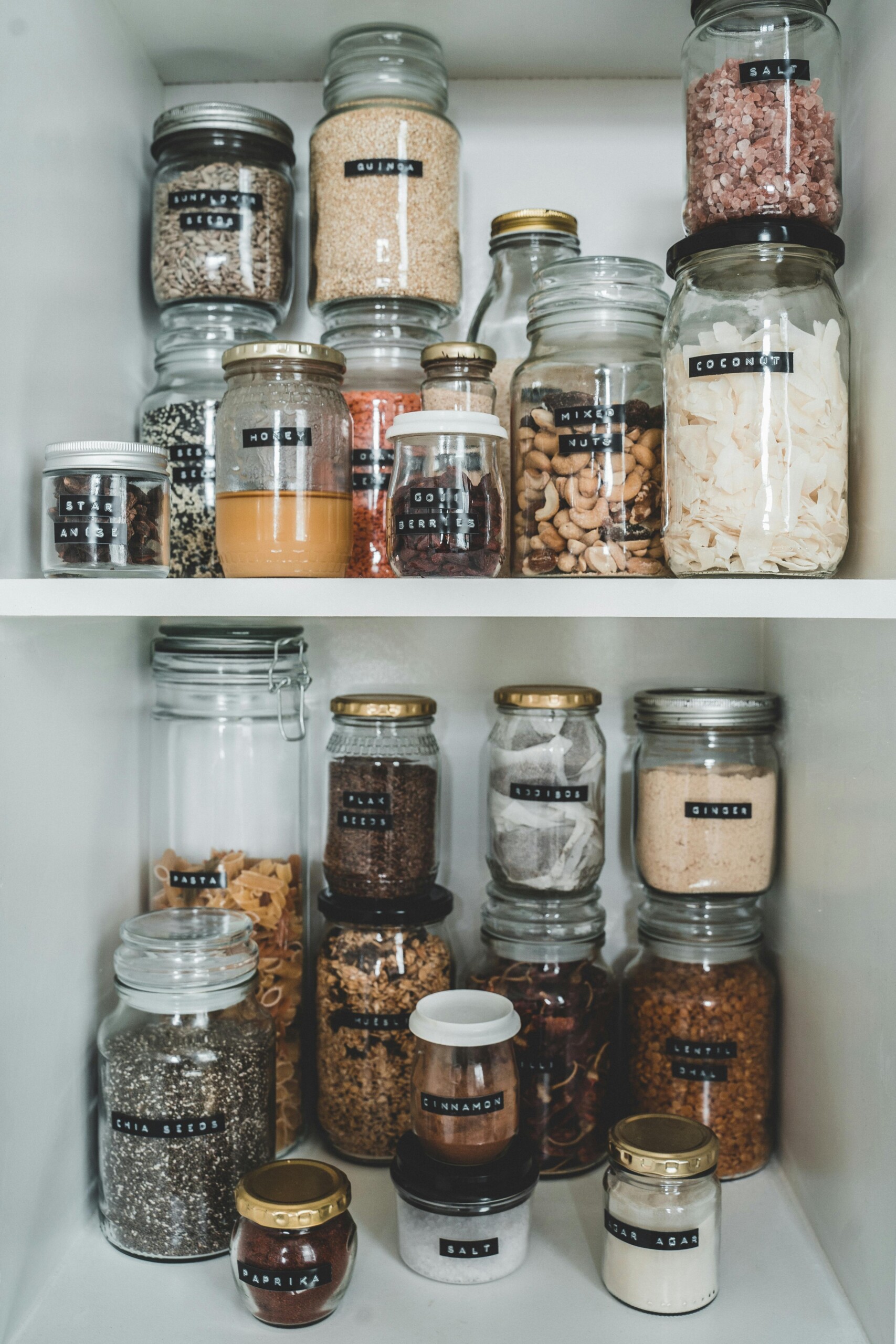 An image with spice jars in an open cupboard. 