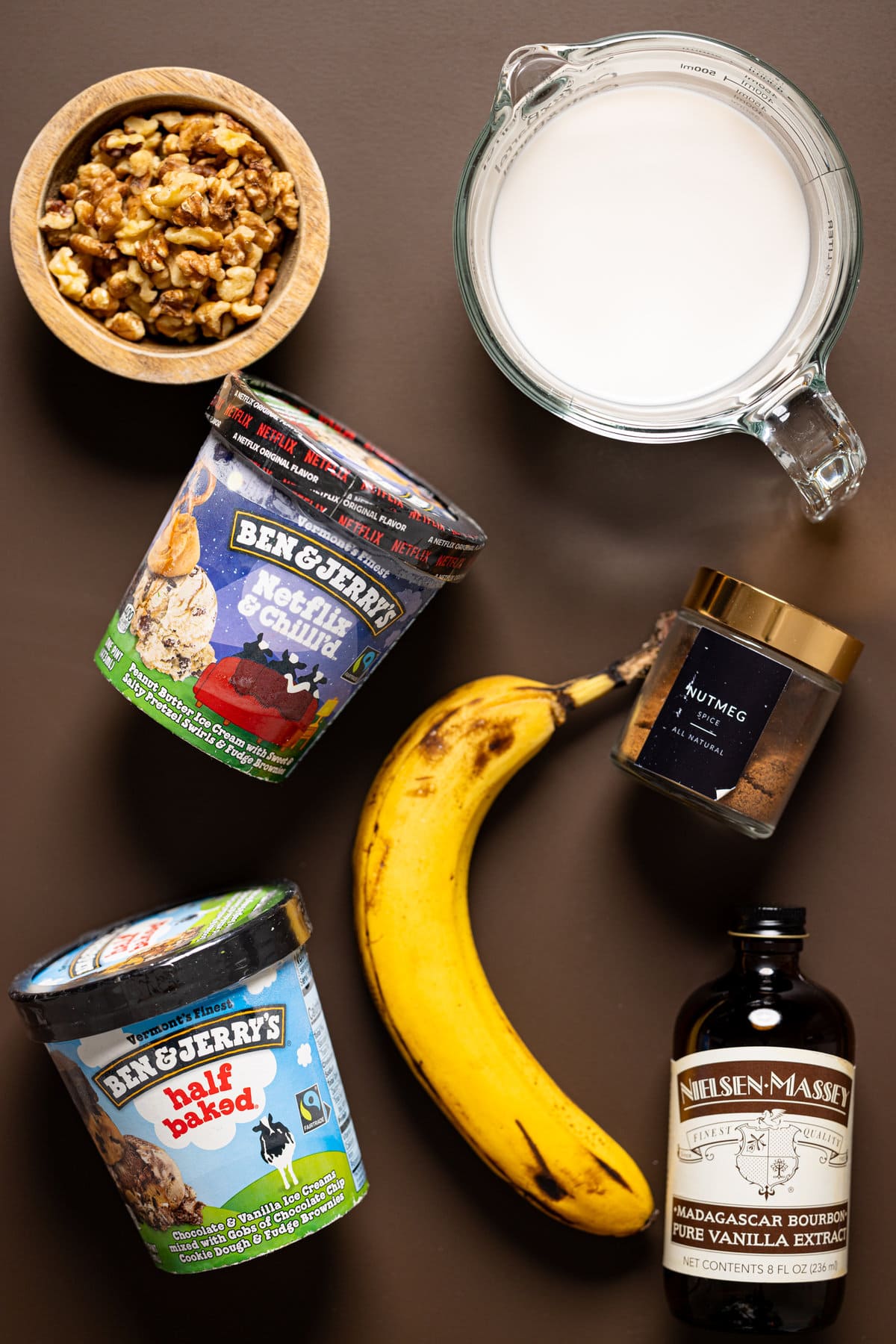 Ingredients for easy Peanut Butter Chunky Monkey Milkshake including Ben & Jerry\'s Ice Cream, a banana, and vanilla extract