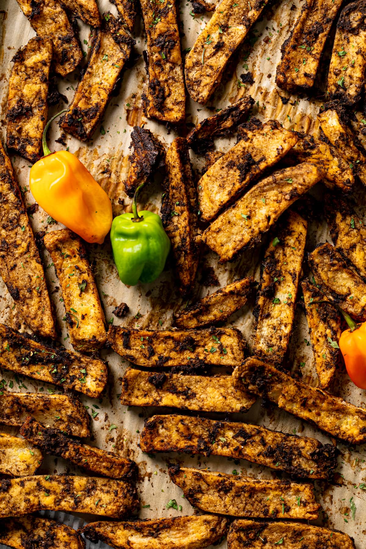 Closeup of Crispy Baked Jerk Potato Wedges on a baking sheet