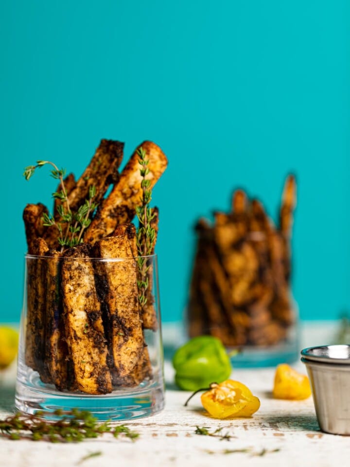 Two glasses stuffed with Crispy Baked Jerk Potato Wedges