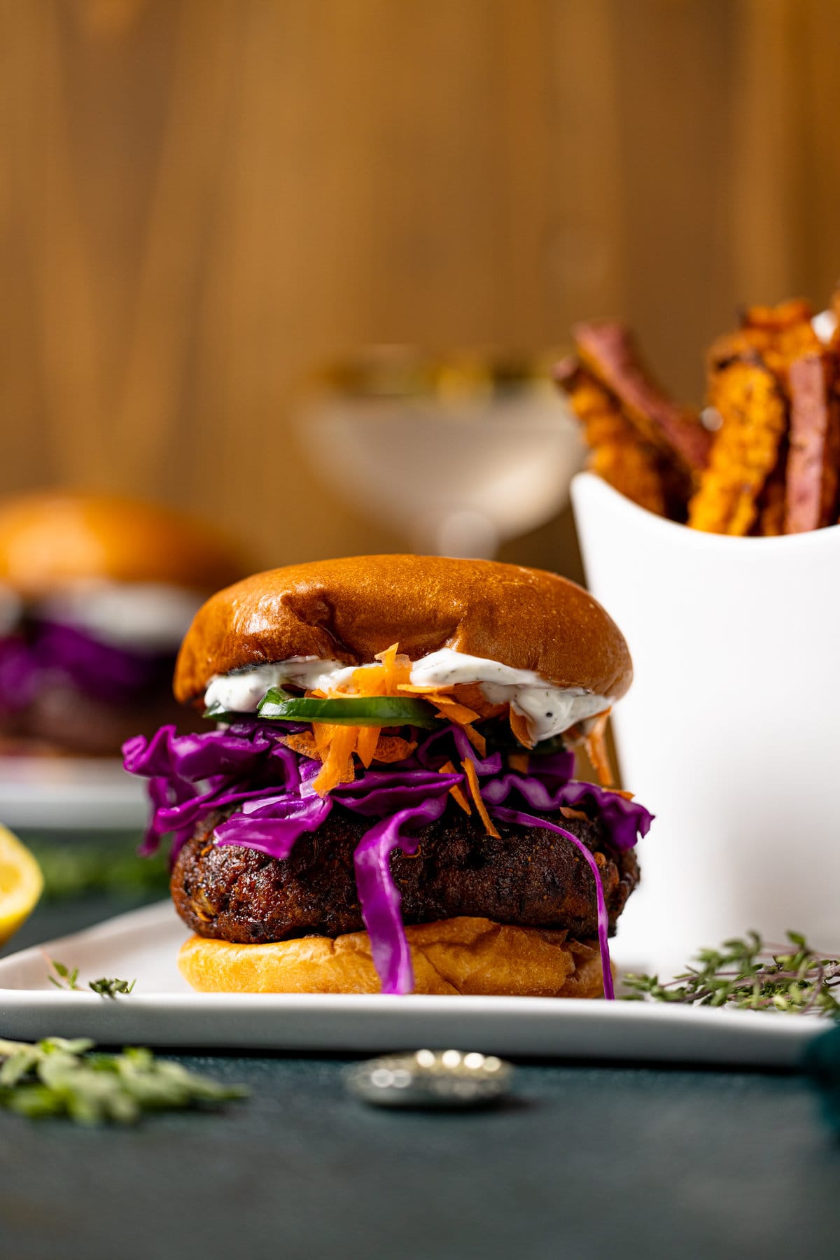 BBQ Jerk Salmon Burger on a plate next to fries