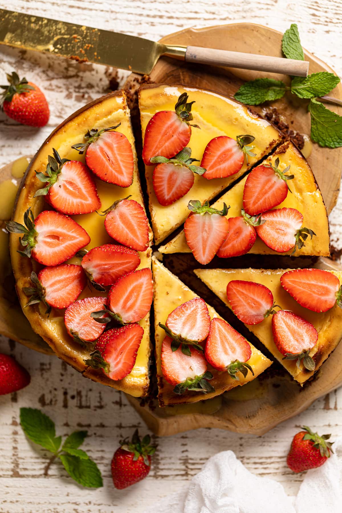 Half-sliced Mango Cheesecake with Chocolate Graham Cracker Crust.