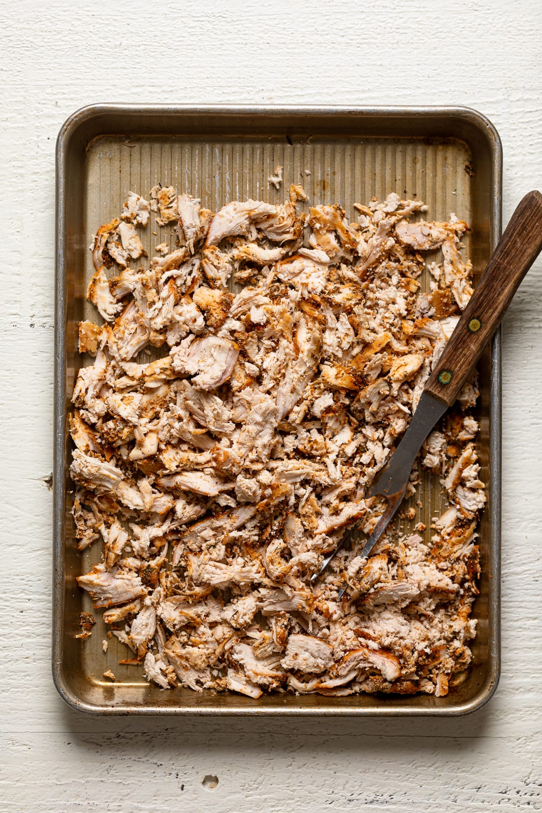 Shredded chicken on a baking sheet