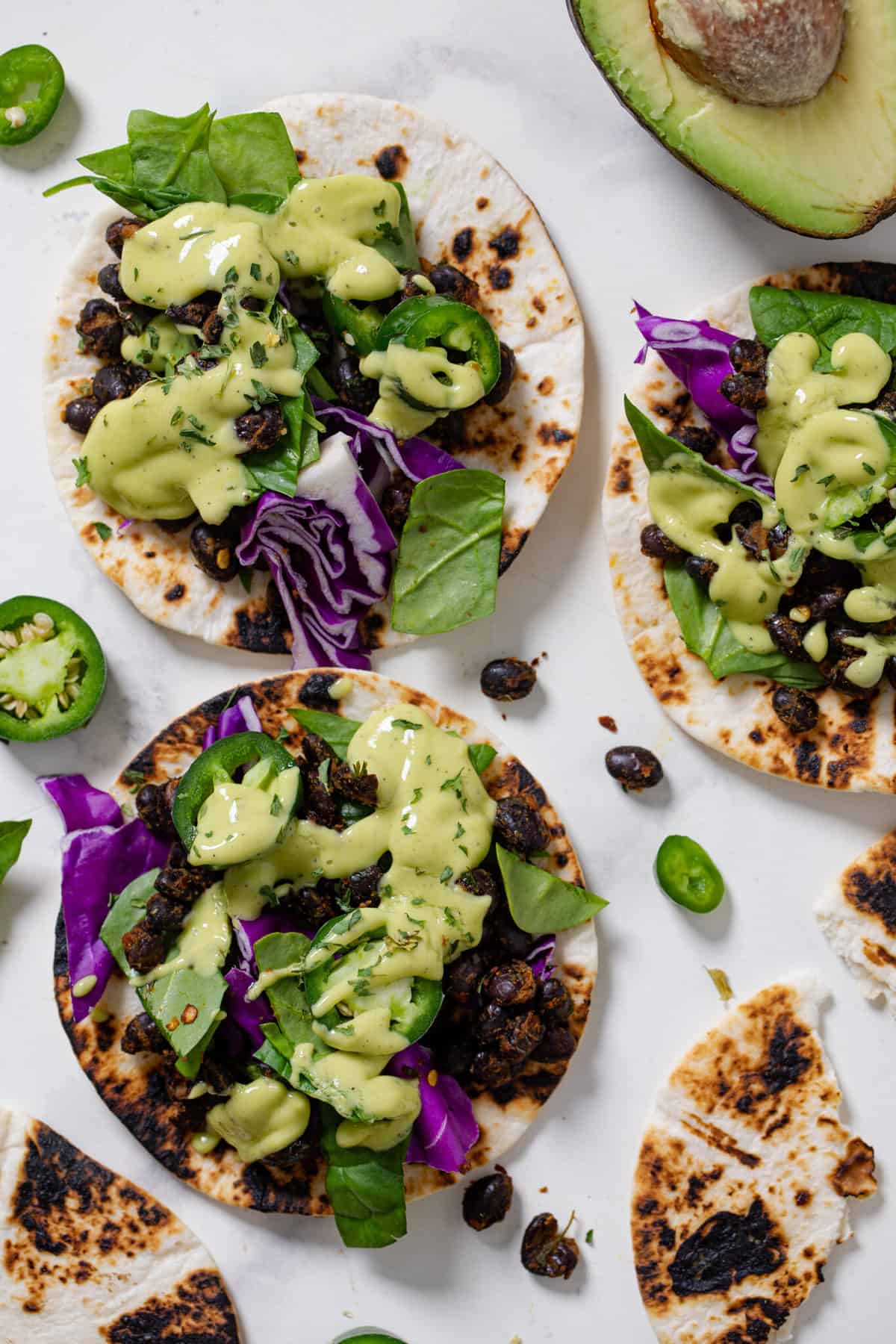 Three Black Bean Tacos with Avocado Basil Mango Sauce.