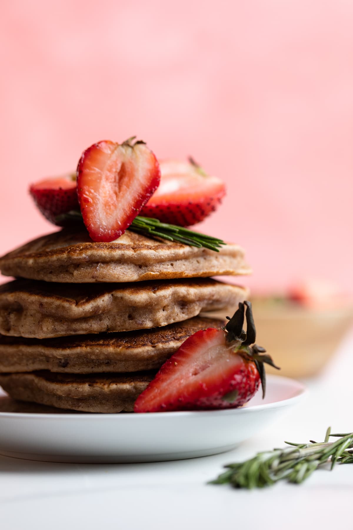 Whole Wheat Strawberry Pancakes topped with halved strawberries.