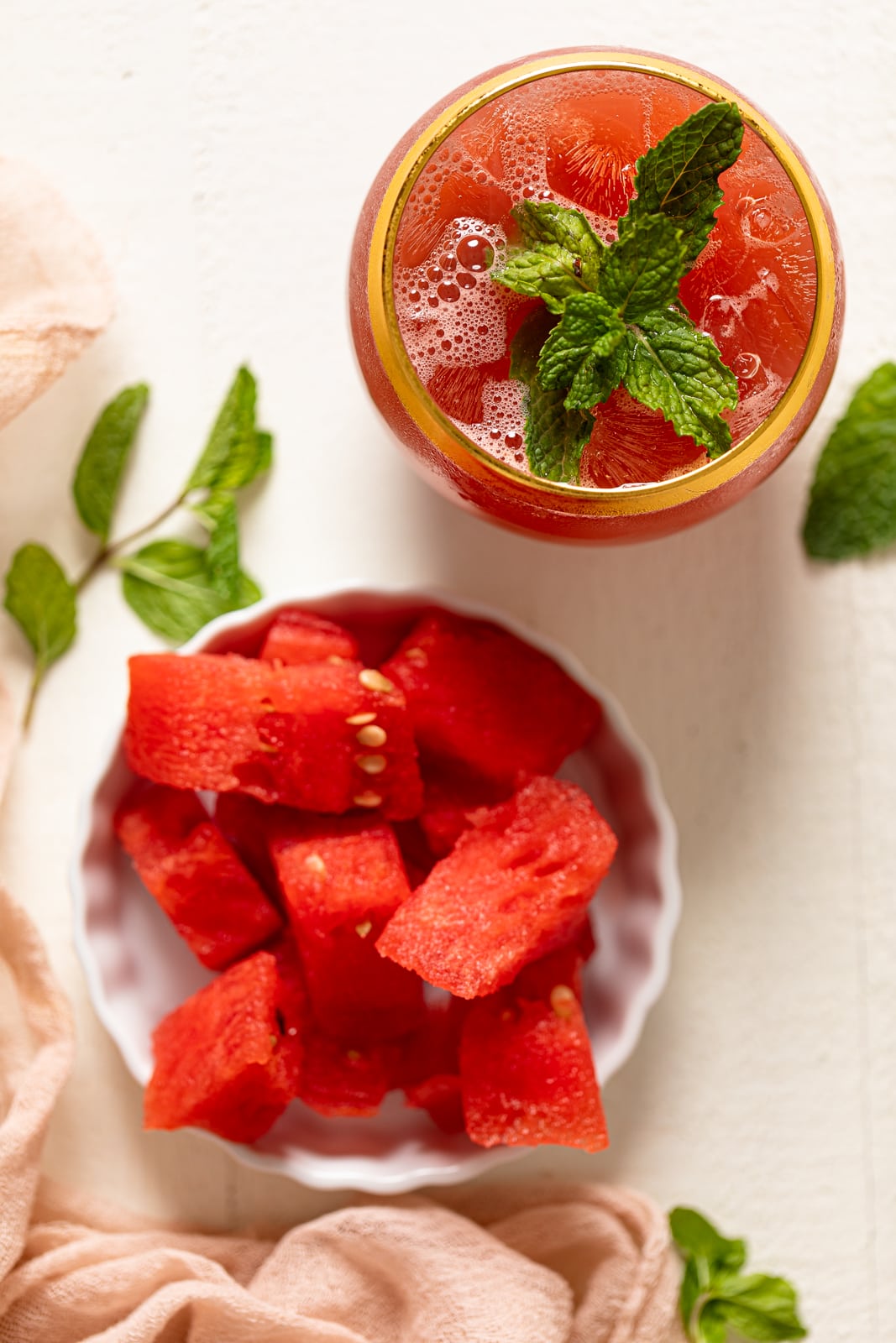 Fresh Watermelon Cucumber Mint Juice with a plate of watermelon pieces.