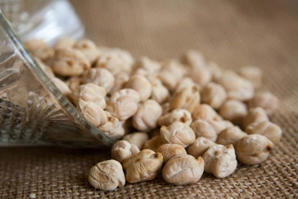 Chickpeas spilling from a bowl.