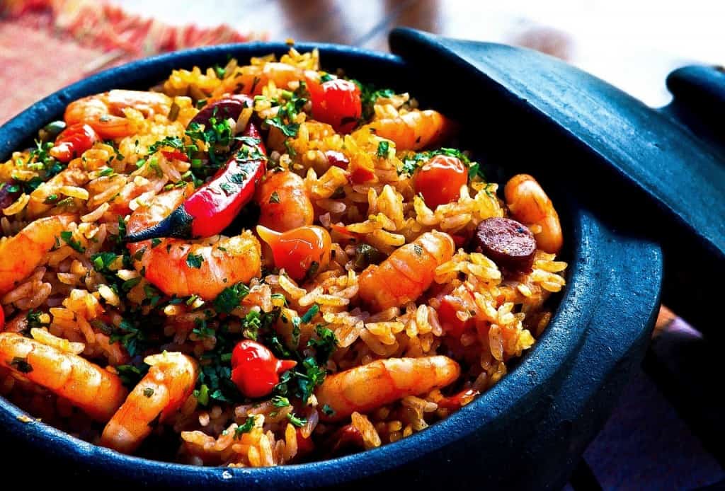 Rice, shrimp, and vegetables in a pot.