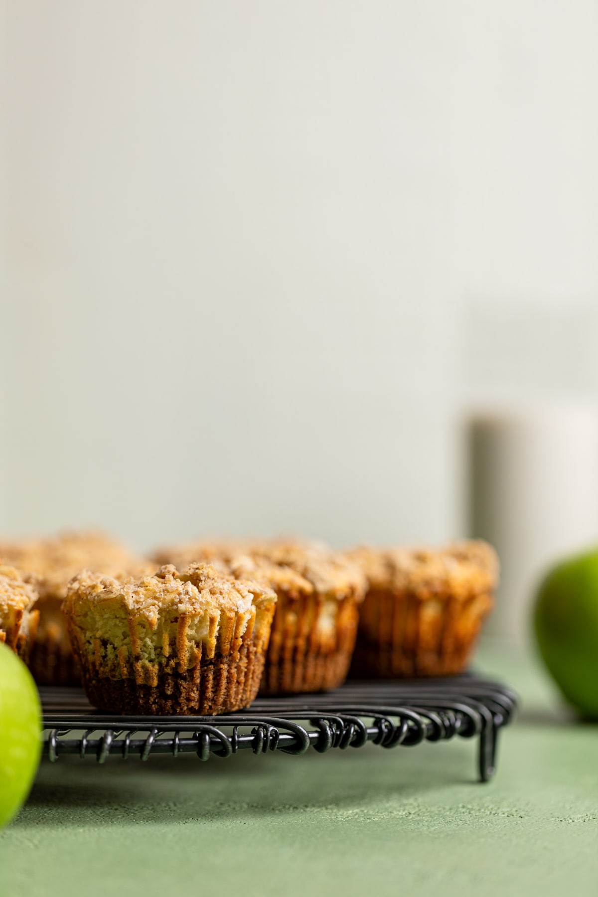 Mini Salted Caramel Apple Streusel Cheesecake Bites on a circular wire rack.