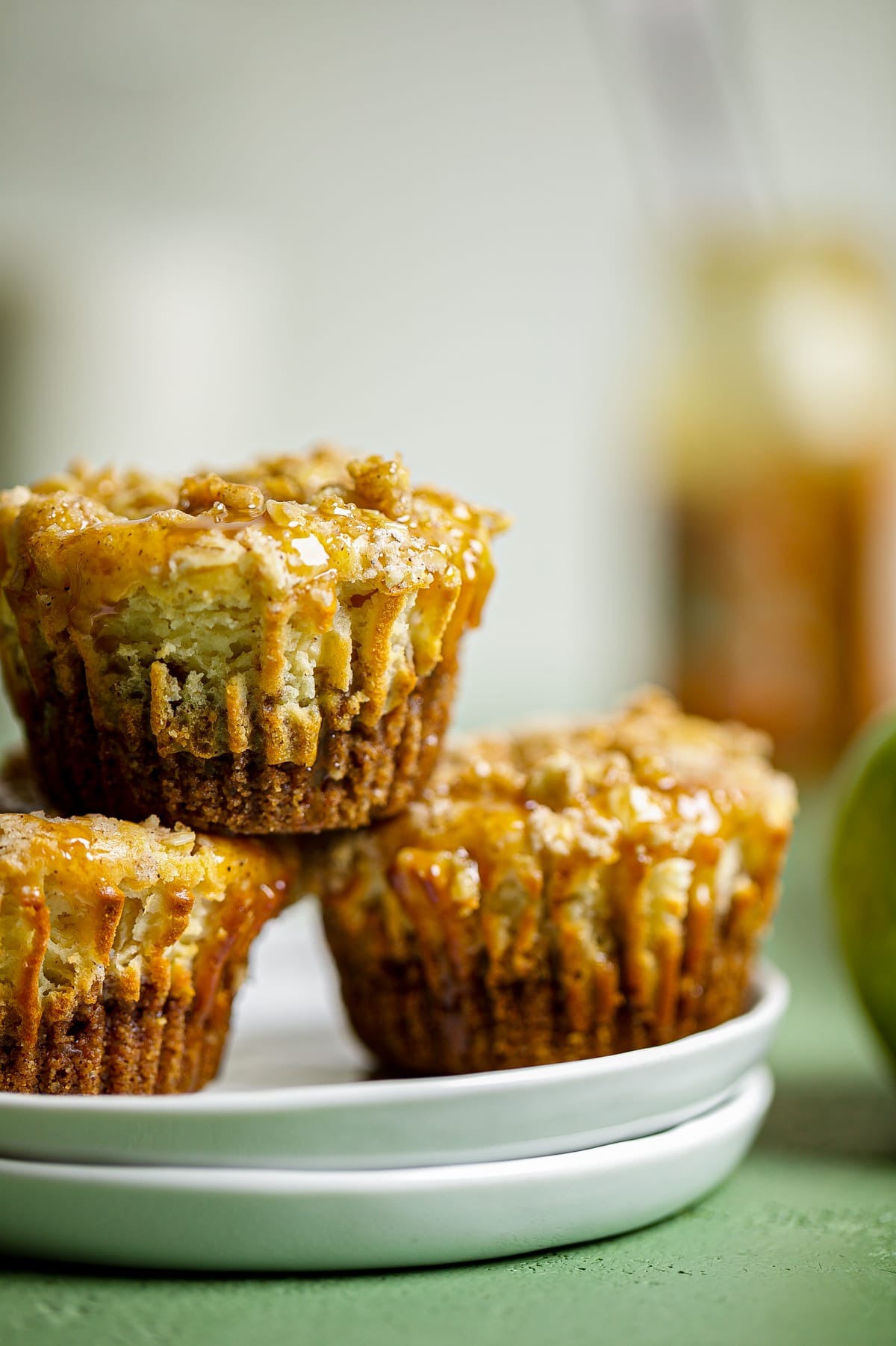 Three Mini Salted Caramel Apple Streusel Cheesecake Bites on a plate.