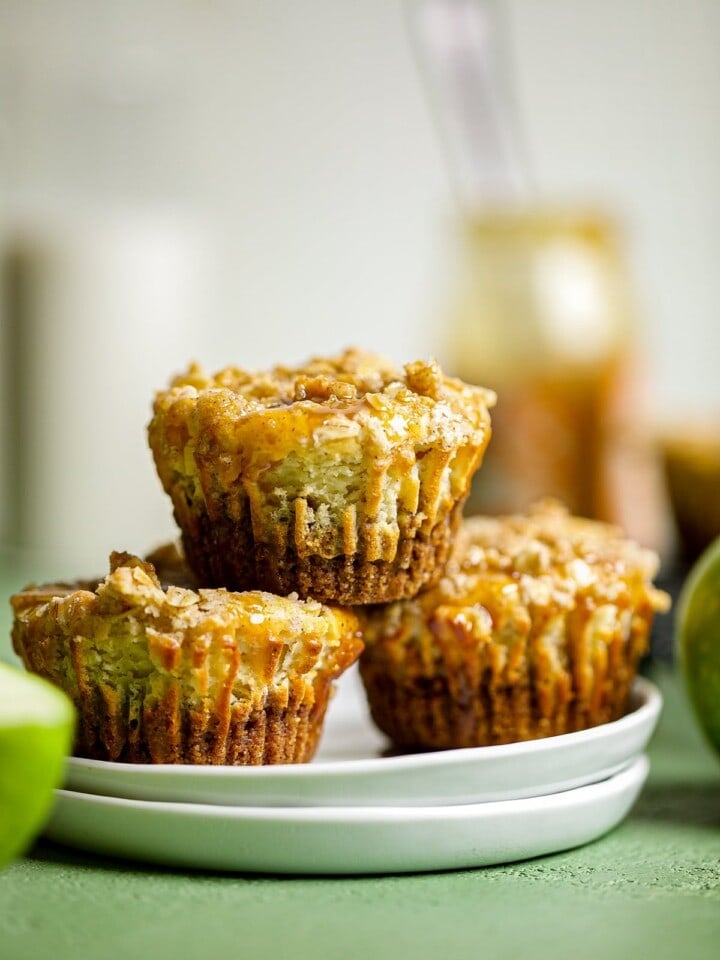 Mini Salted Caramel Apple Streusel Cheesecake Bites piled on two small plates.