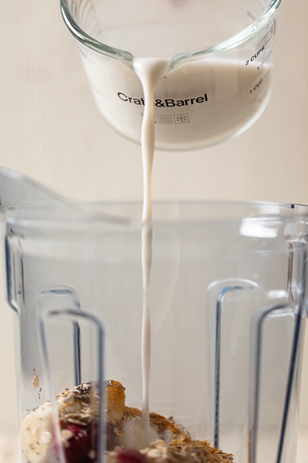 Coconut milk pouring into a blender.