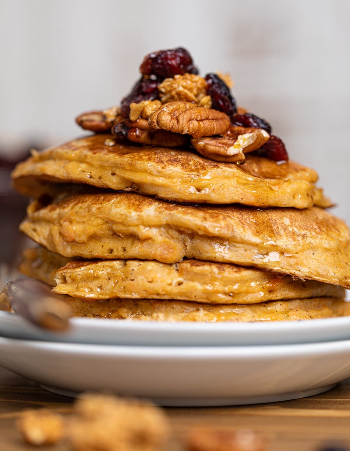 Sweet Potato Pancakes stacked on white plates.