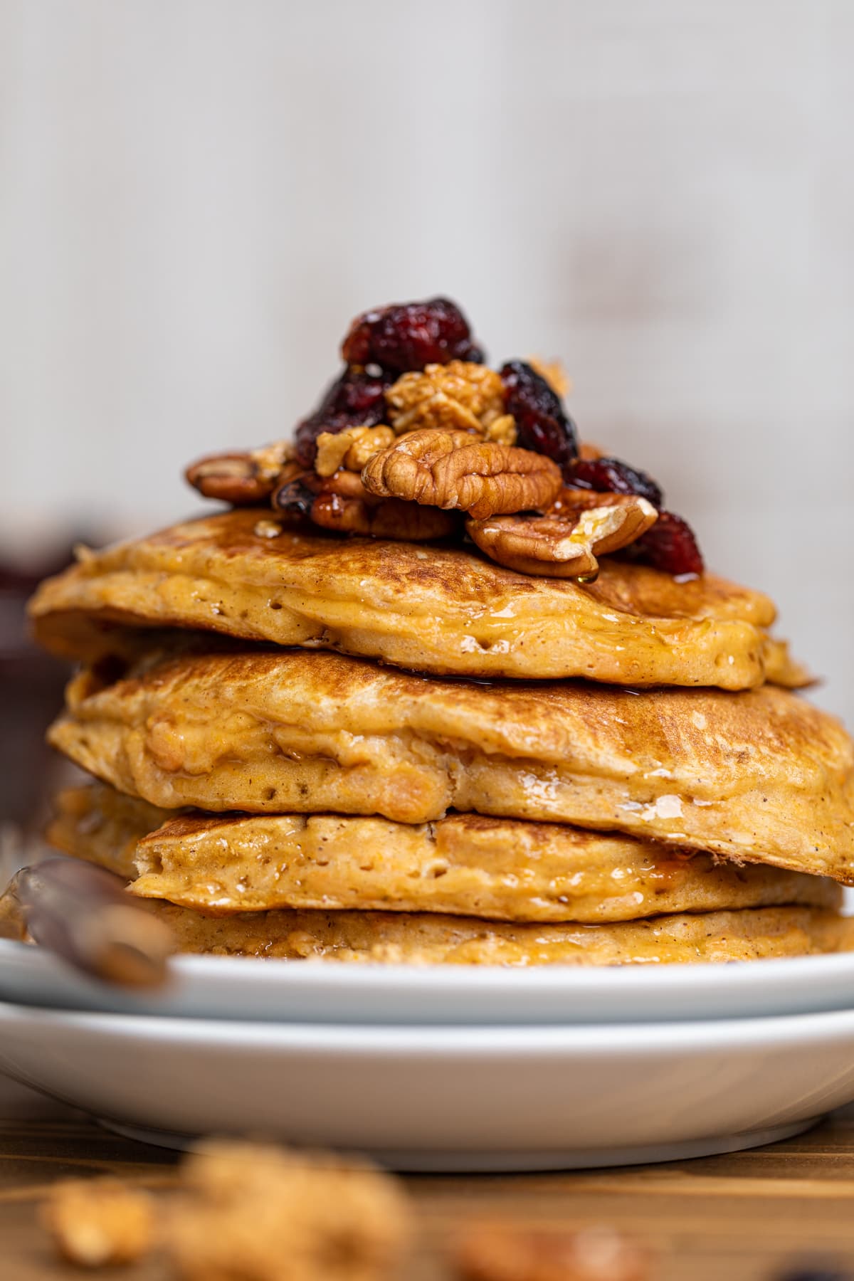 Sweet Potato Pancakes stacked on white plates.