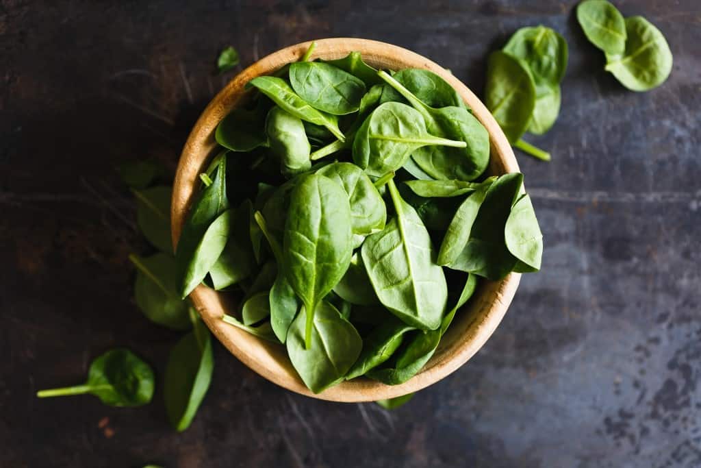 Wooden bowl of spinach.