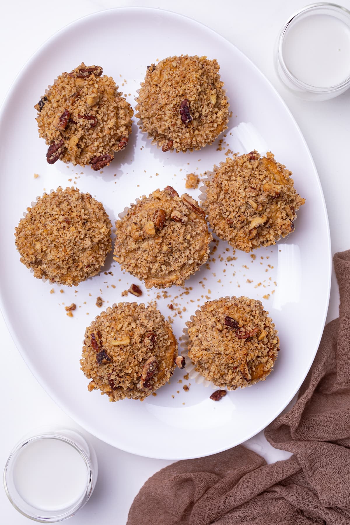 Vegan Banana Muffins with cinnamon streusel on a white plate.