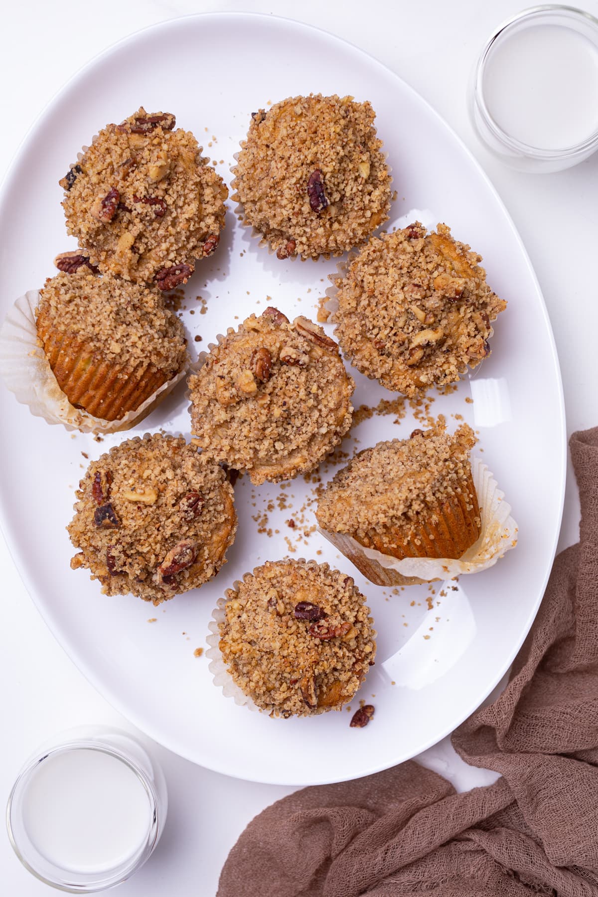 Vegan Banana Muffins with cinnamon streusel on a white plate.