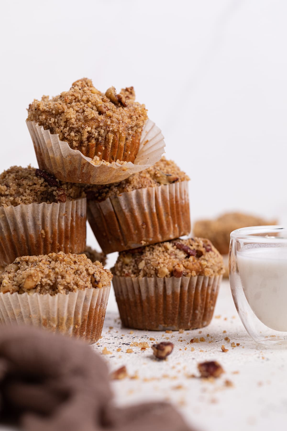 Stack of Vegan Cinnamon Banana Crumble Muffins.