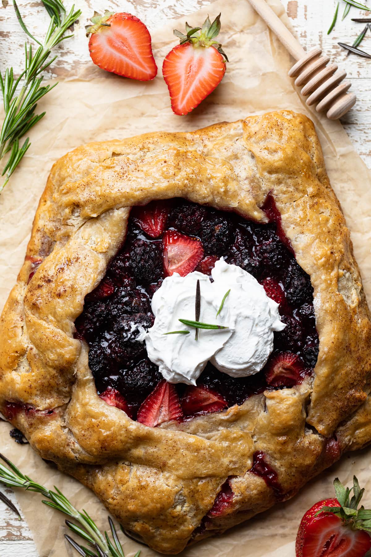 Vegan Berry Galette topped with whipped cream.