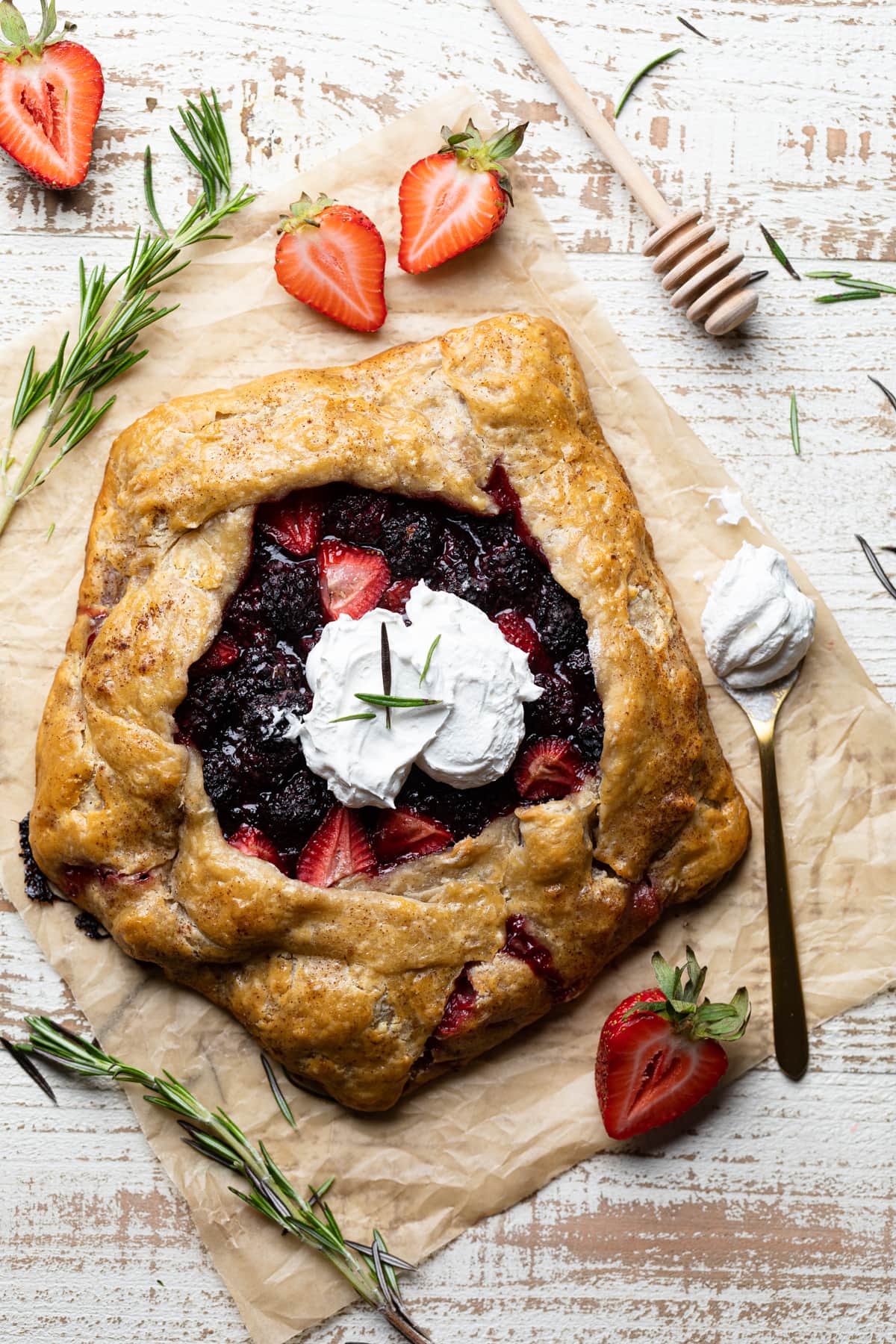 Spoon of whipped cream with a Vegan Berry Galette.