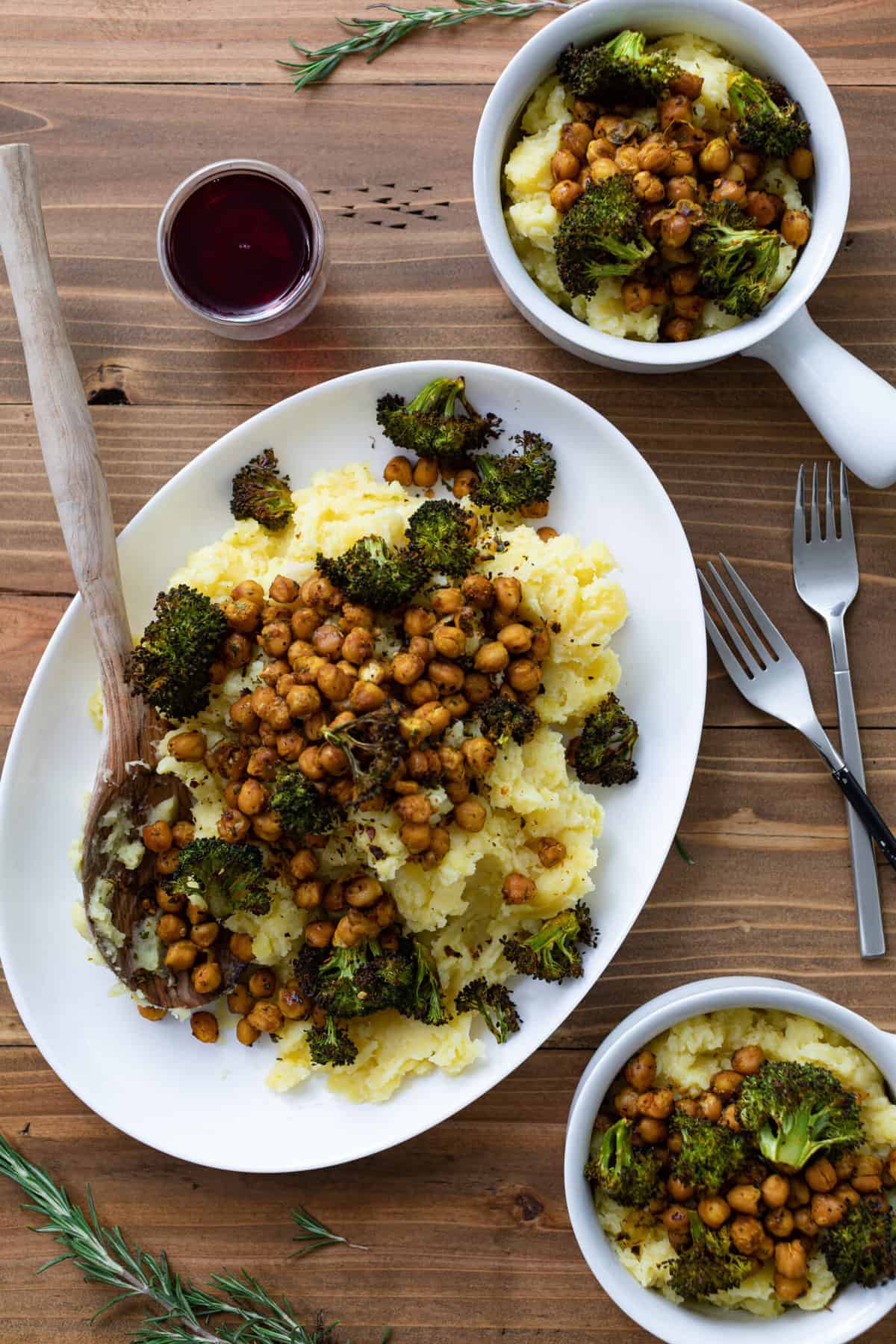 Wooden spoon on a plate of Vegan Chickpeas and Broccoli Mashed Potatoes.