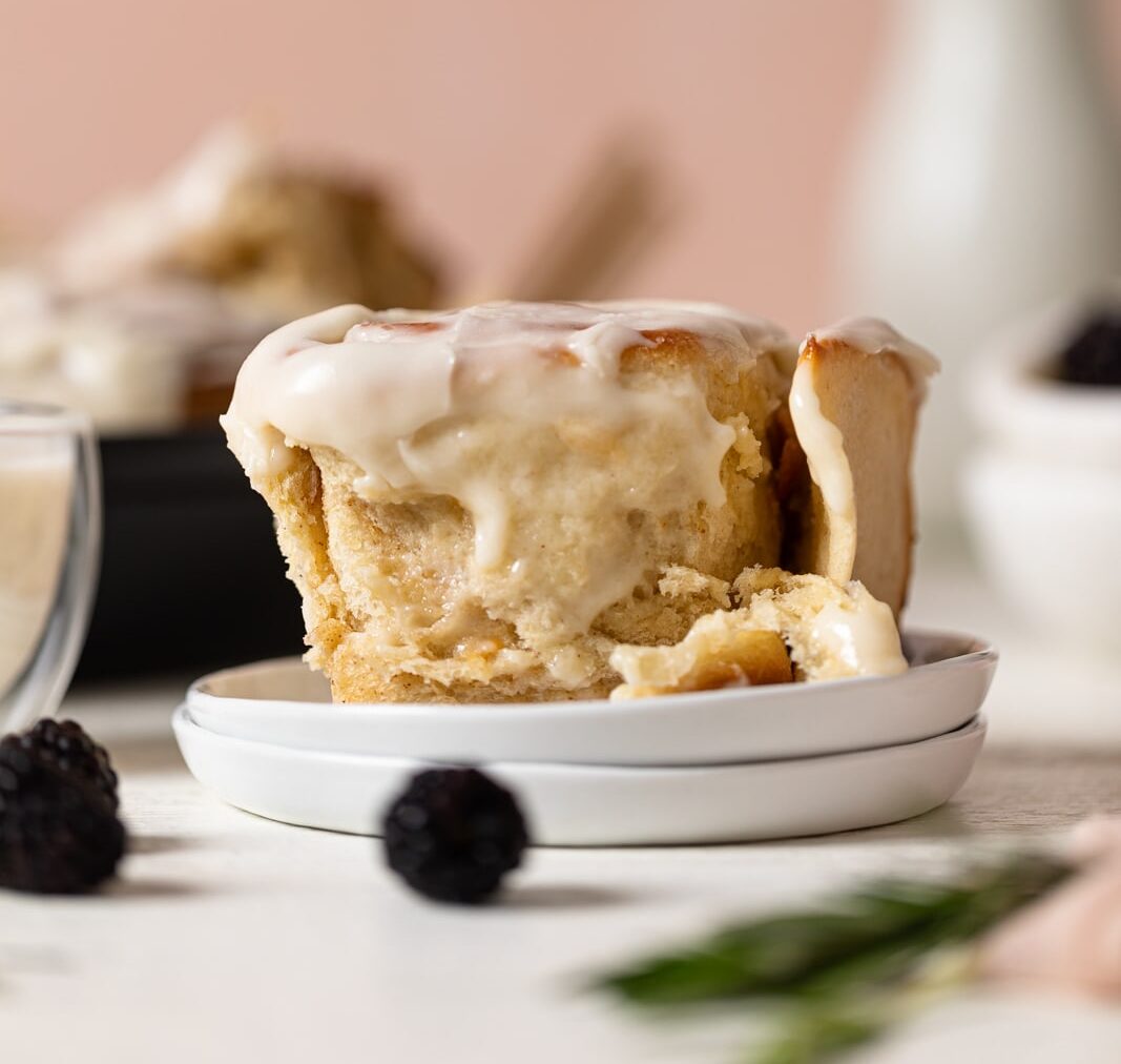 Delicious Homemade Classic Cinnamon Roll on two small, stacked plates.