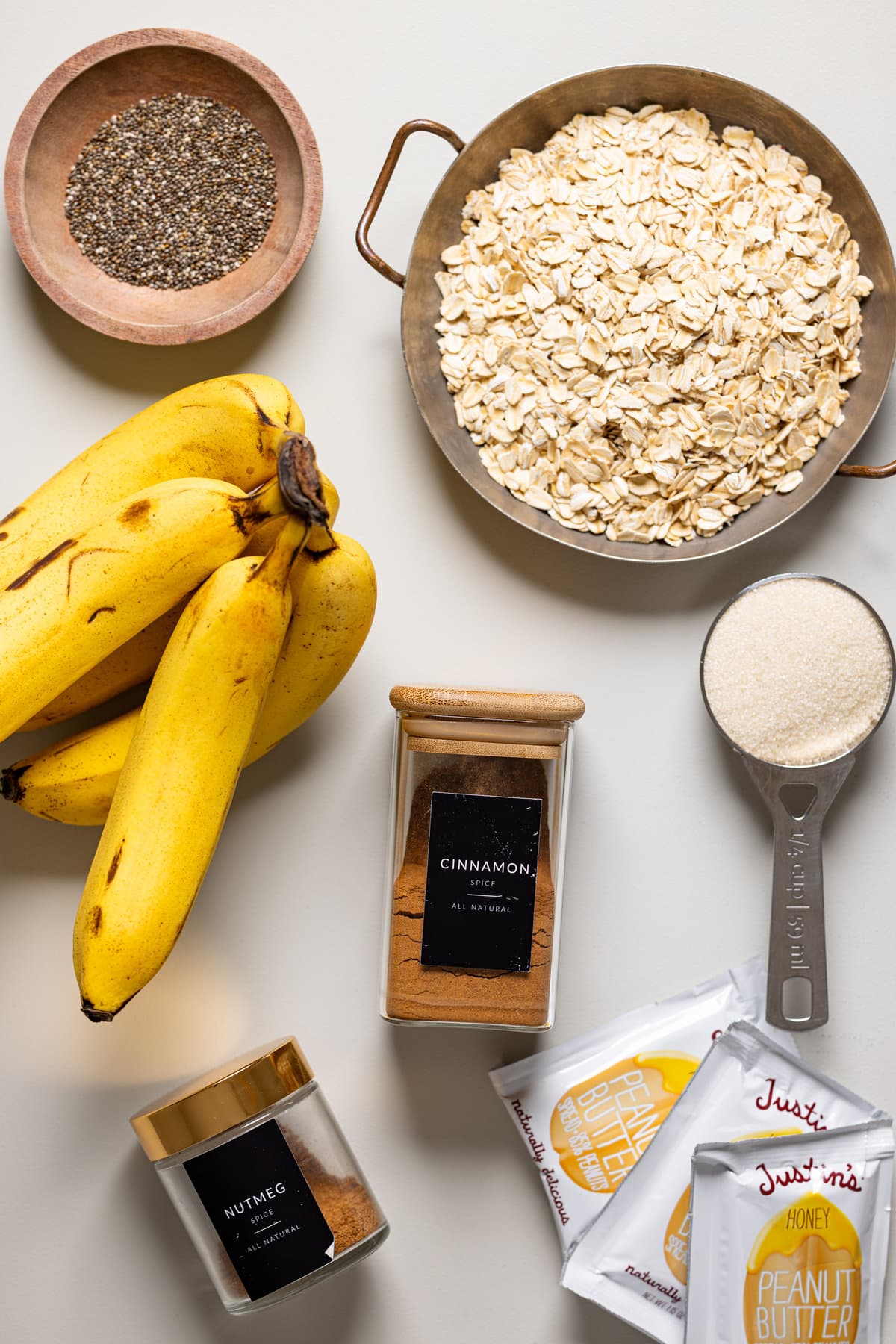 Ingredients for Protein Peanut Butter Banana Chia Oatmeal including bananas, cinnamon, and honey peanut butter