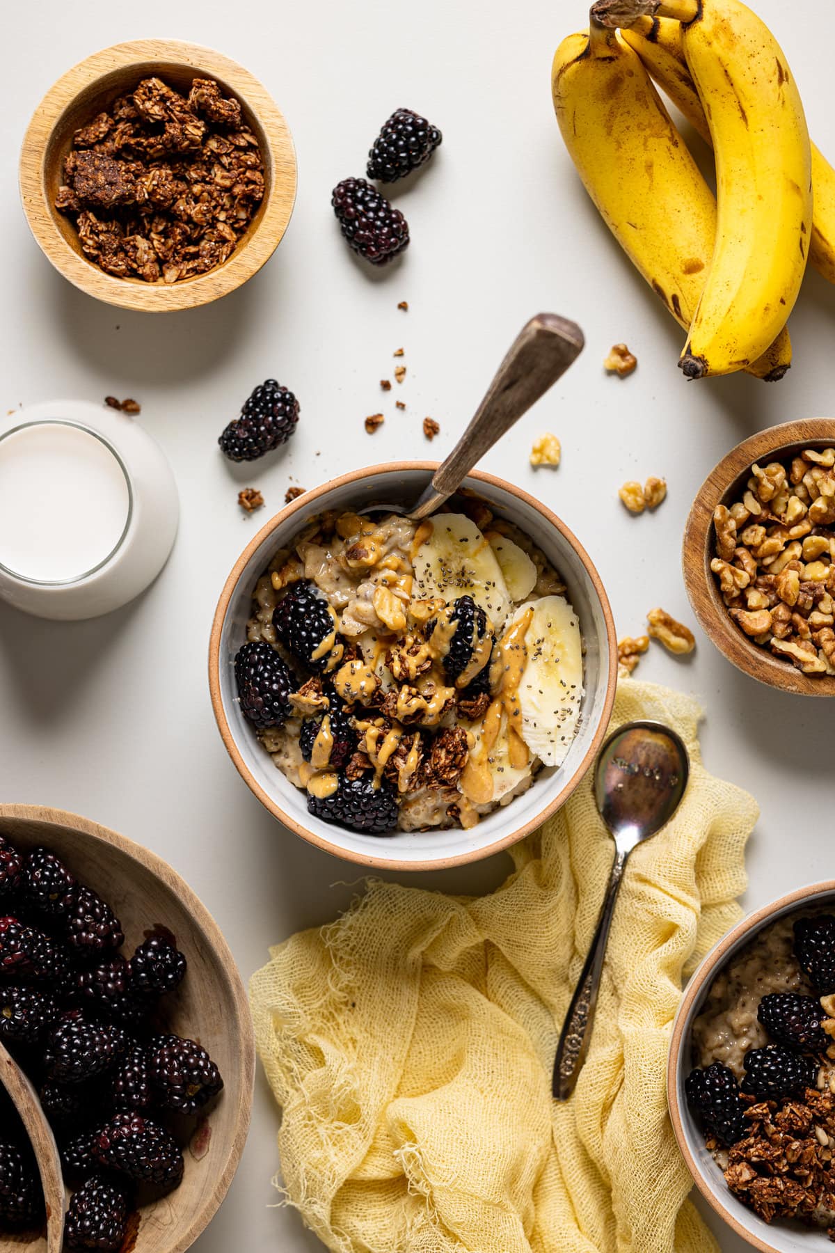 Overhead shot of a bowl of Protein Peanut Butter Banana Chia Oatmeal surrounded by toppings
