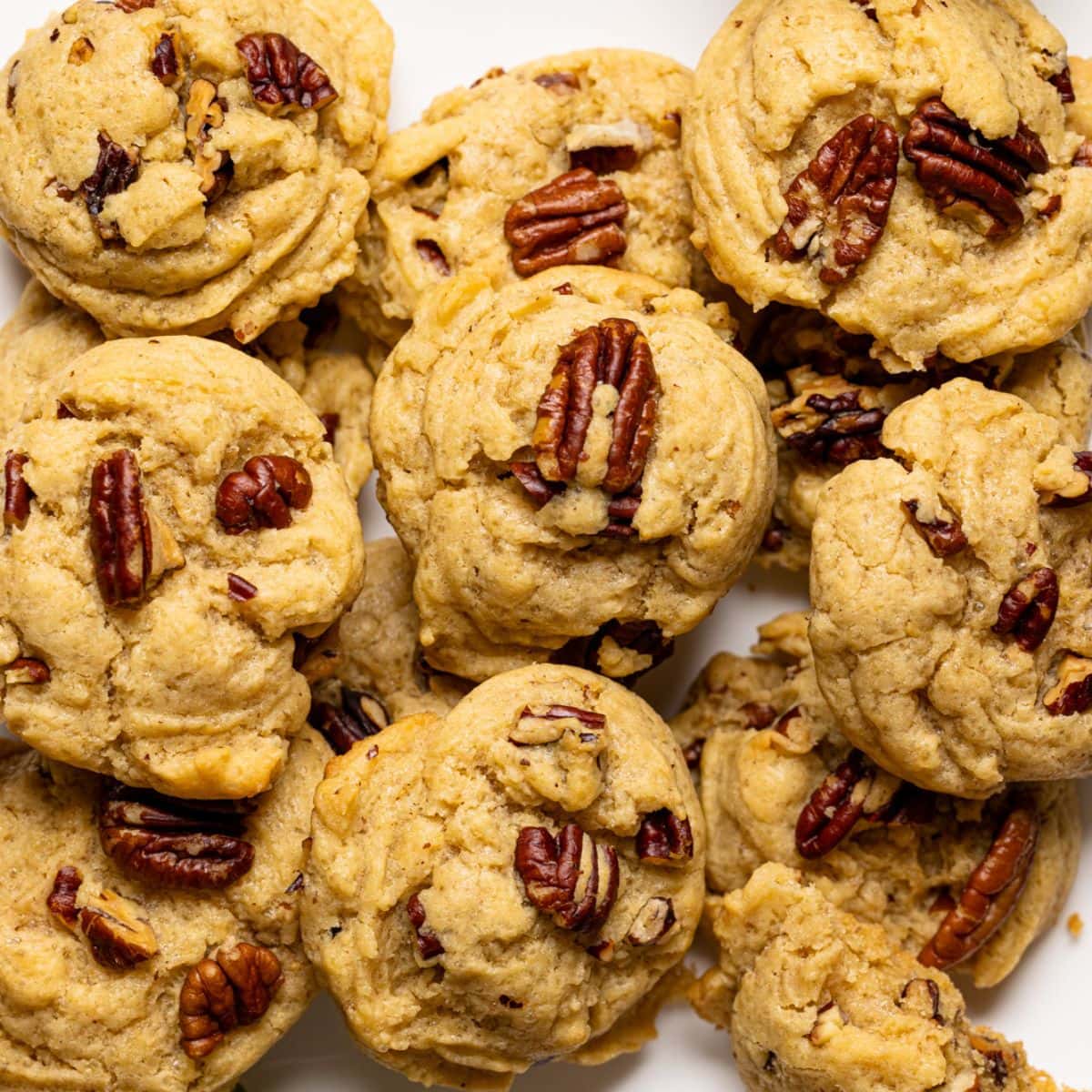 Up close shot of baked cookies on a white plate.