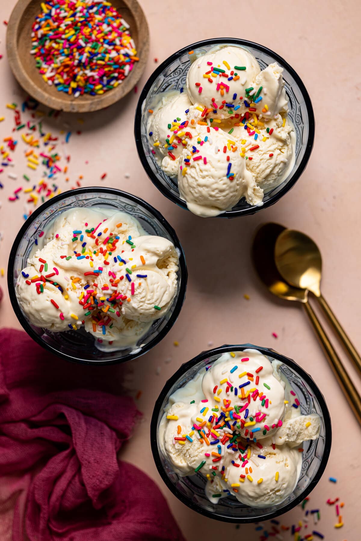 Gold spoons next to bowl of No-Churn Vanilla Ice Cream.