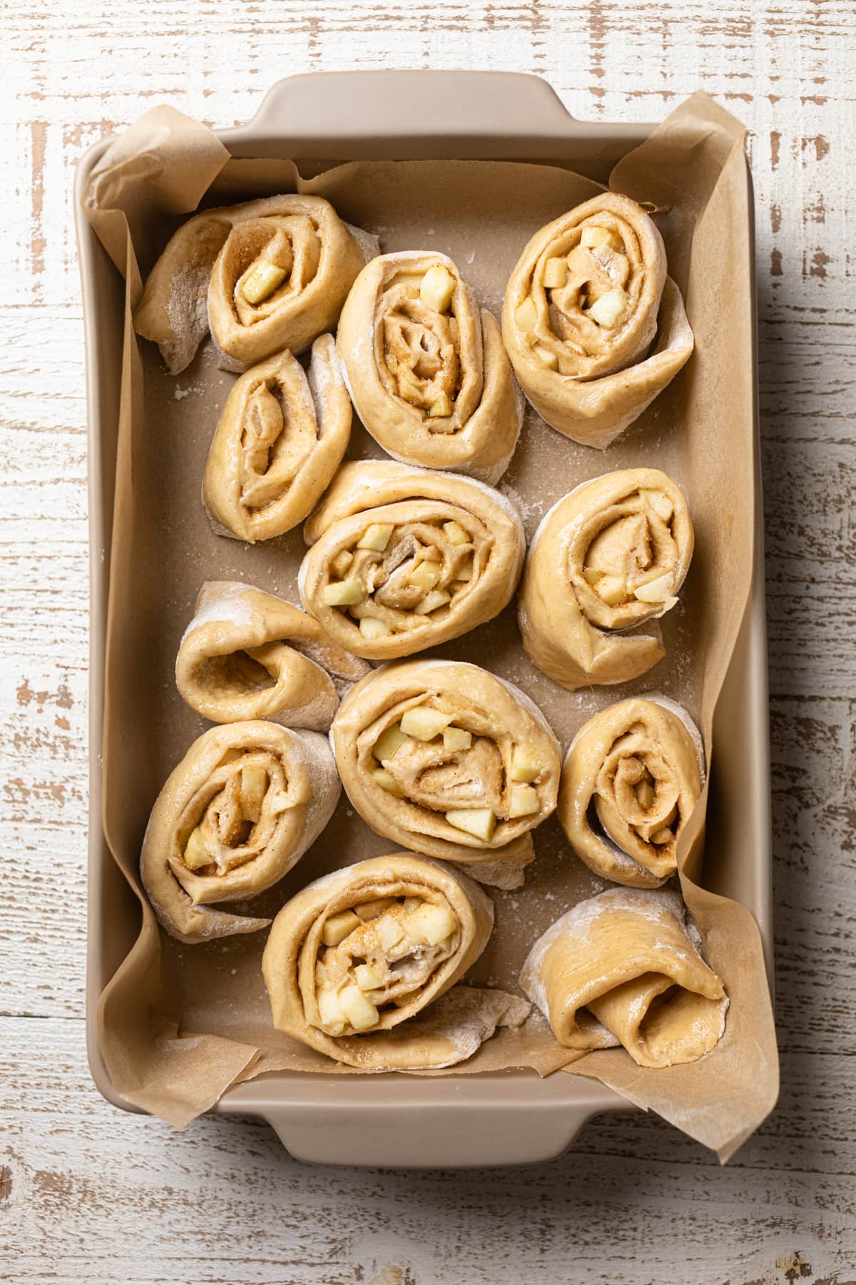 Uncooked Vegan Apple Cinnamon Rolls in a baking dish