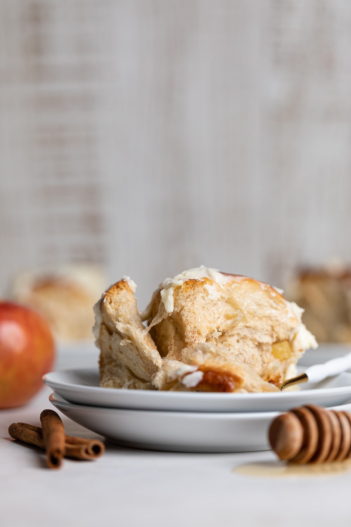 Vegan Apple Cinnamon Roll on two small, stacked plates