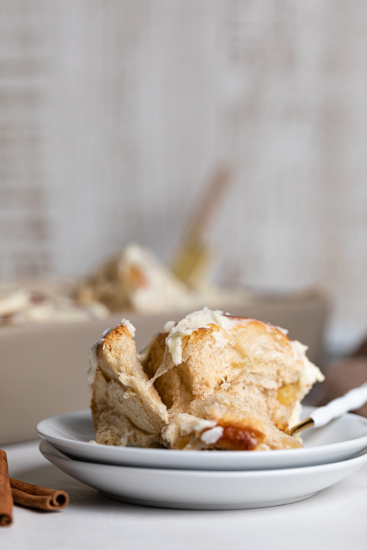 Vegan Apple Cinnamon Roll on two small, stacked plates