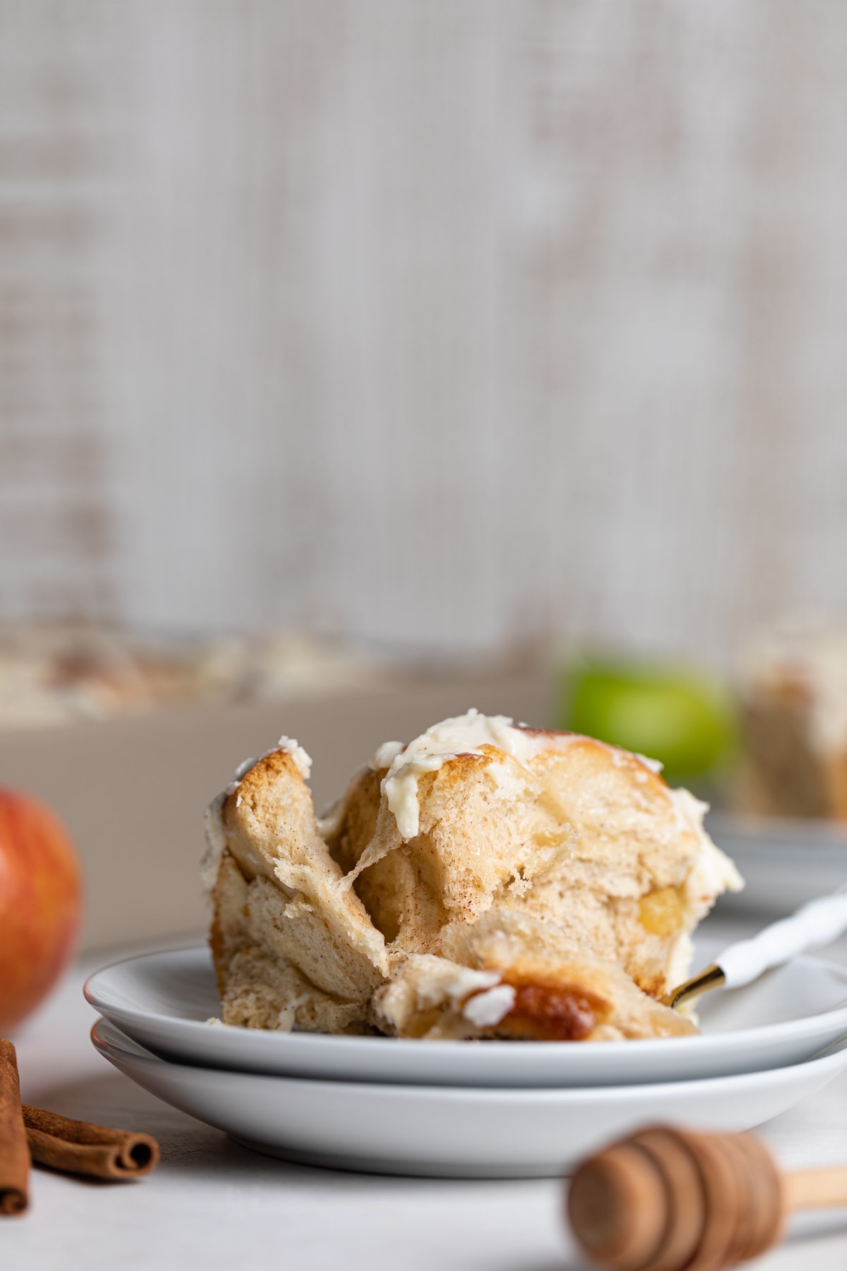 Vegan Apple Cinnamon Roll on a small plate with a fork