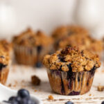 Vegan Banana Blueberry Pecan Crumble Muffins on a white table