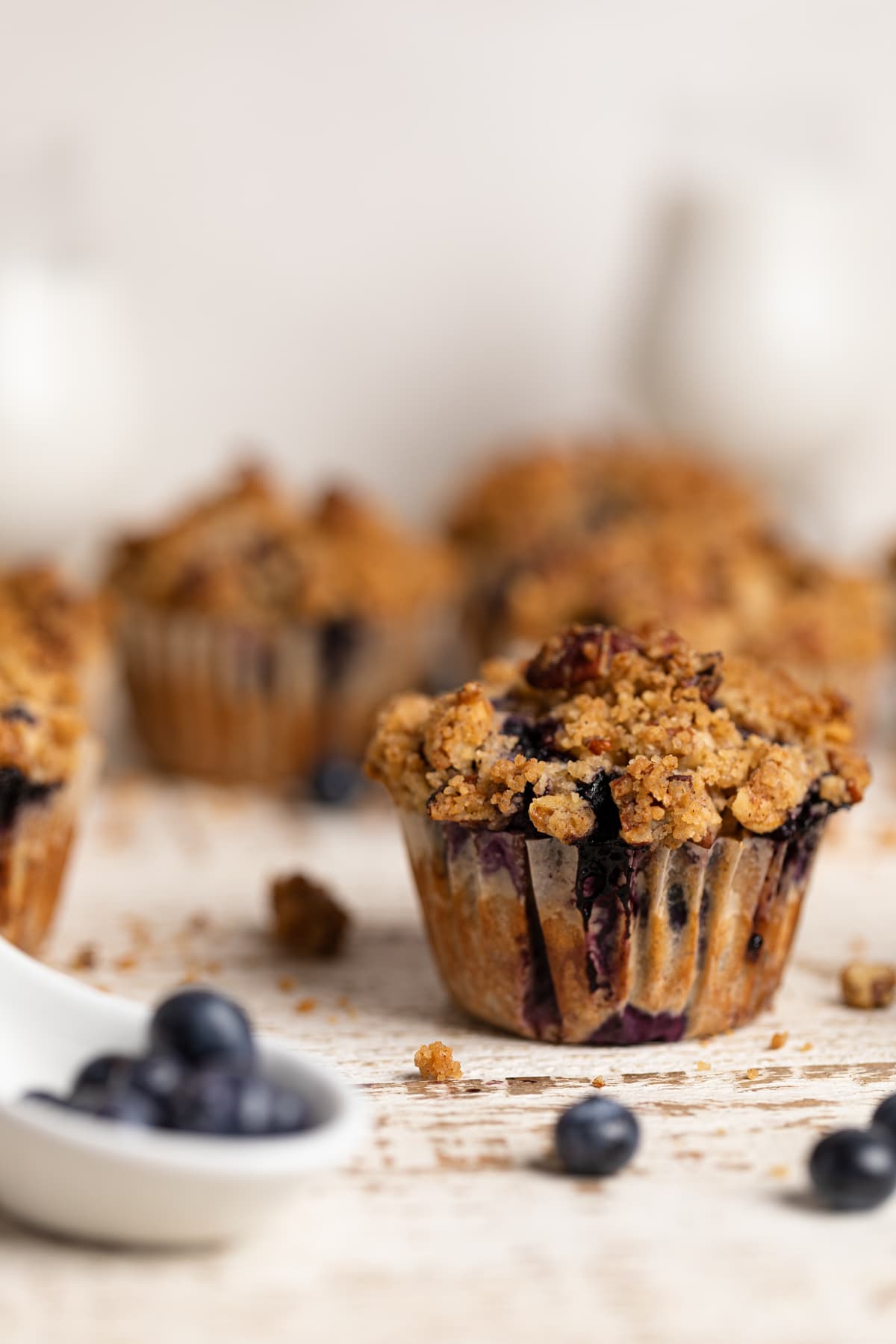 Vegan Banana Blueberry Pecan Crumble Muffins on a white table