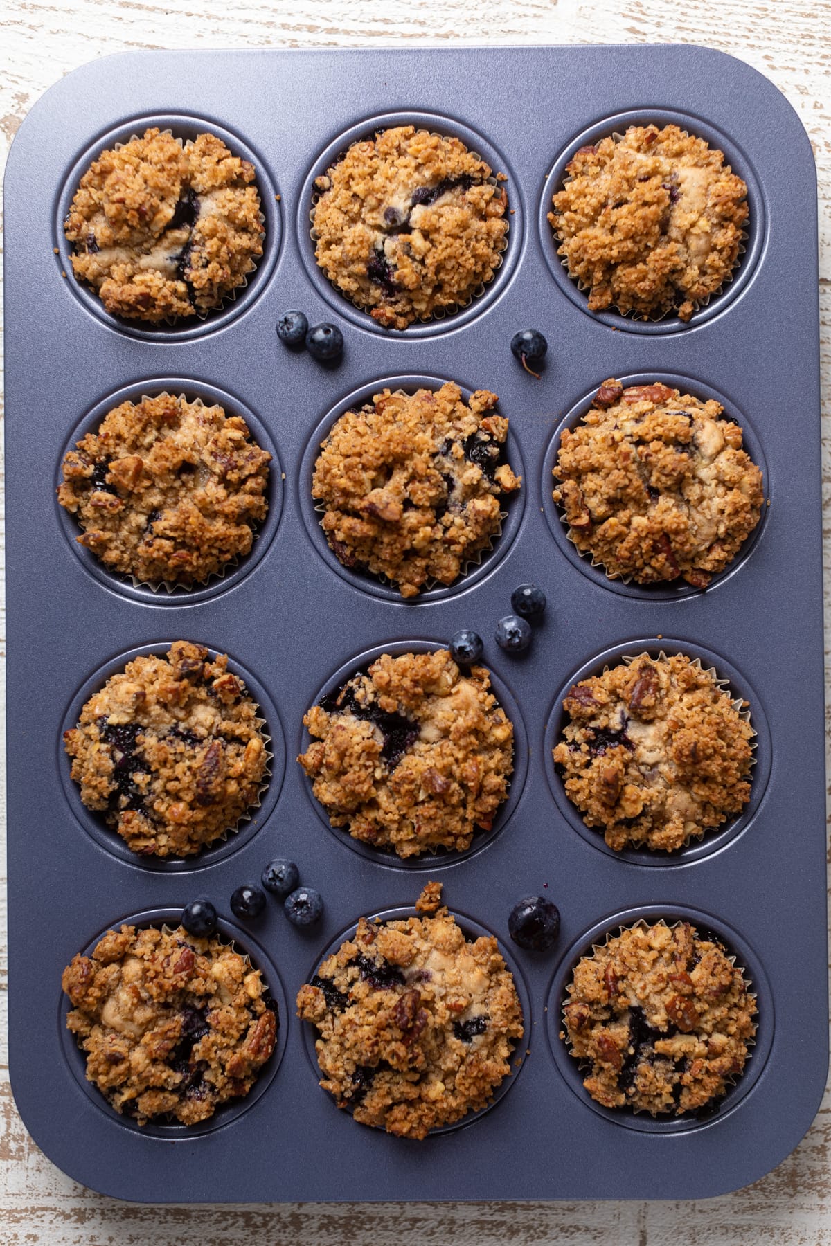 Vegan Banana Blueberry Pecan Crumble Muffins in a muffin pan