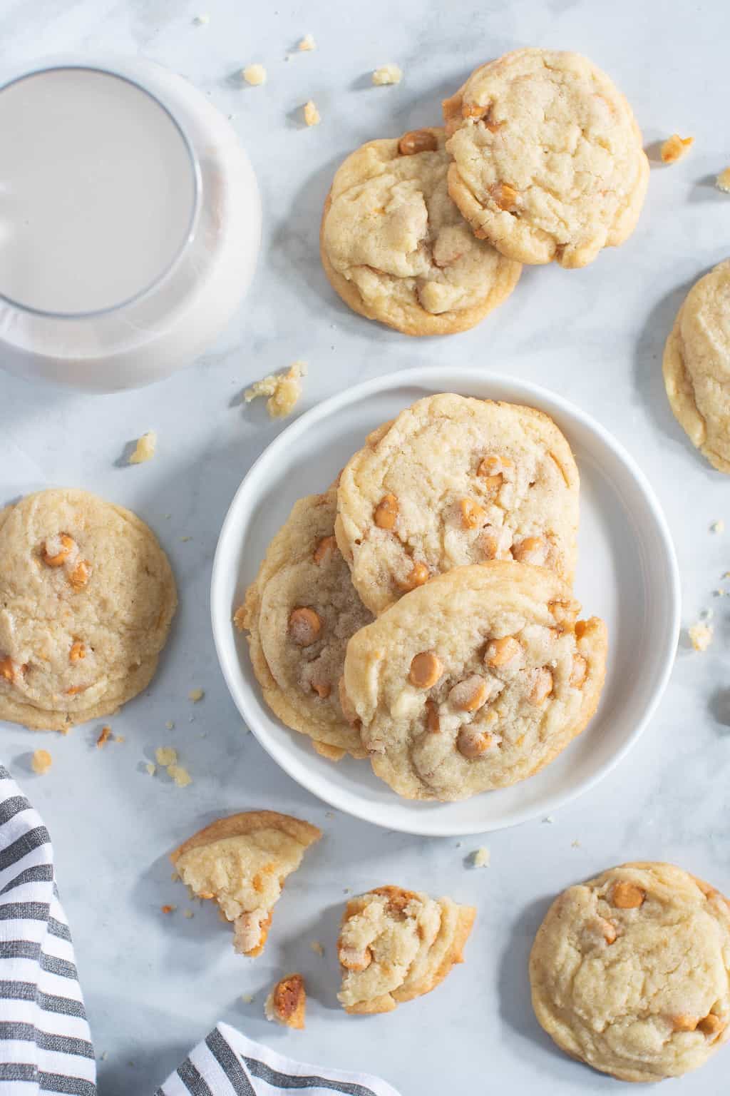 Soft and Crisp Crinkled Butterscotch Cookies on and around a plate.