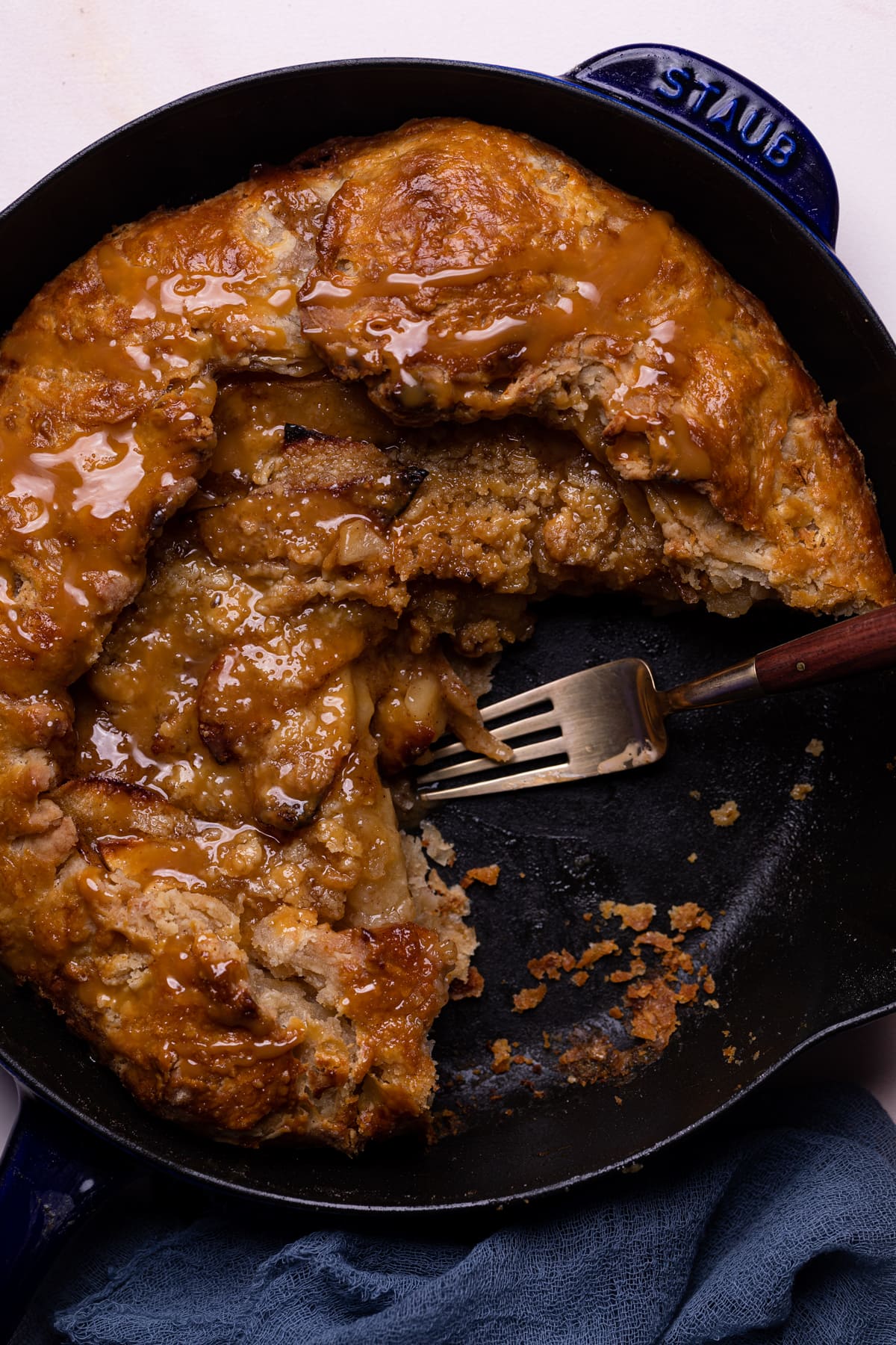 Fork in a partially-served Salted Caramel Apple Skillet Galette.