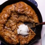 Salted Caramel Apple Skillet Galette on a table with a blue cloth napkin.